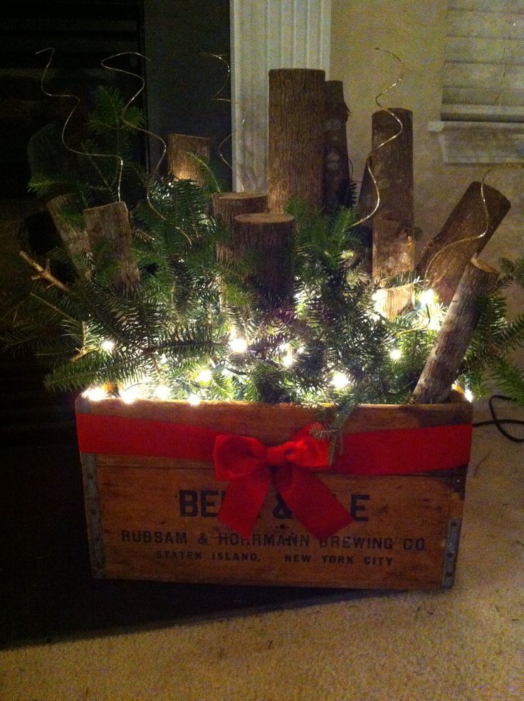 a wooden crate filled with christmas trees and lights