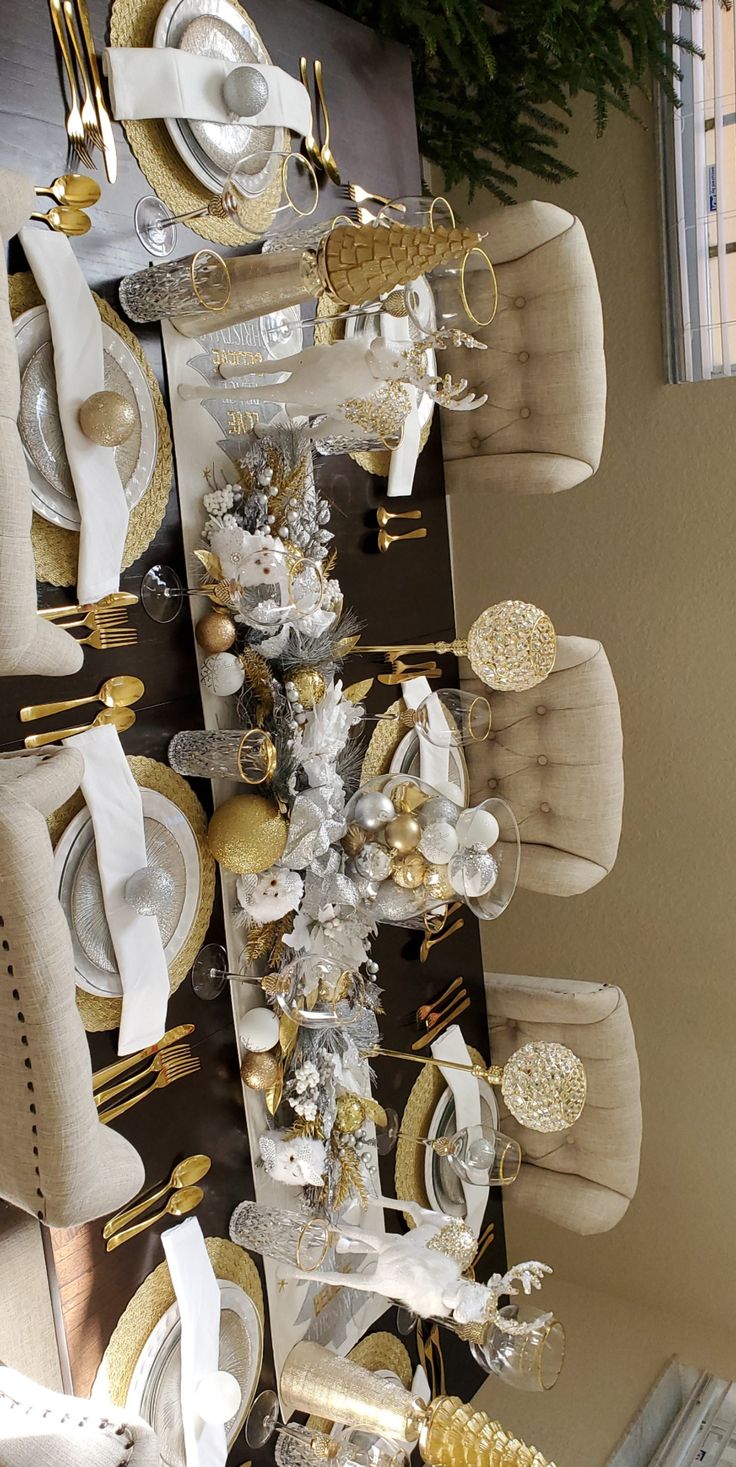 a dining room table with gold and white decorations