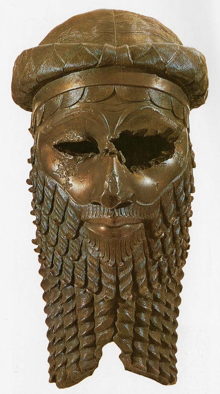 a bronze colored skull wearing a hat with spikes on it's head and beard