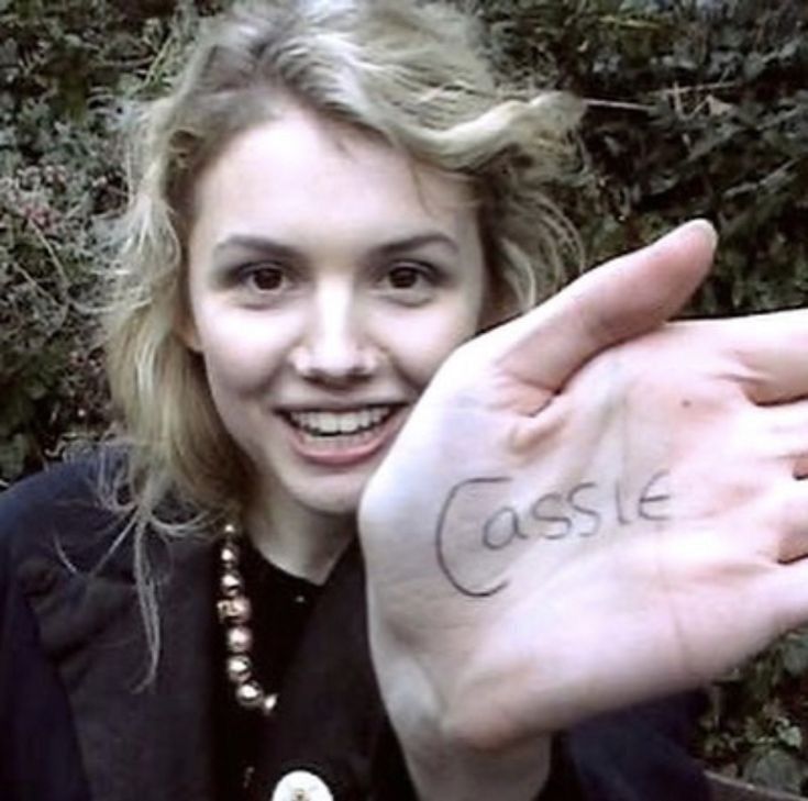 a woman holding up her hand with the word castle written on it