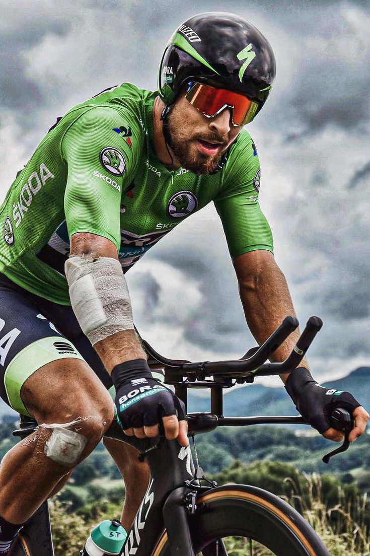 a man riding a bike on top of a lush green field