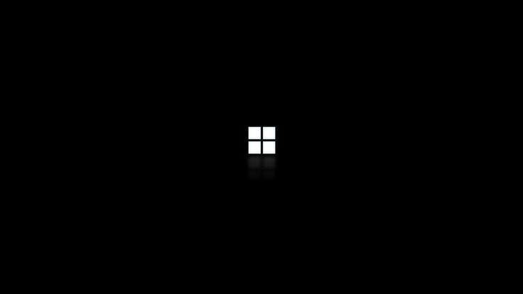 an open window in the middle of a dark room with only one light on it