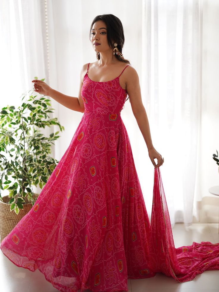 Introducing our stunning "pretty pink bandhani printed chiffon festival wear gown with dupatta" - a must-have for your festive wardrobe! This beautiful pink color gown features intricate bandhani print work, adding a touch of traditional charm. The chiffon fabric adds a touch of elegance, making it perfect for festivals, functions, and special events.
The matching chiffon dupatta with bandhani print work and fancy lace border work completes the look, giving you a coordinated and stylish outfit. Anarkali Backless Designs, Chiffon Anarkali Dress, Chudi Designs, Flair Gown, Chiffon Anarkali, Bandhej Print, Dark Green Wedding, Gown With Dupatta, Gown Pattern