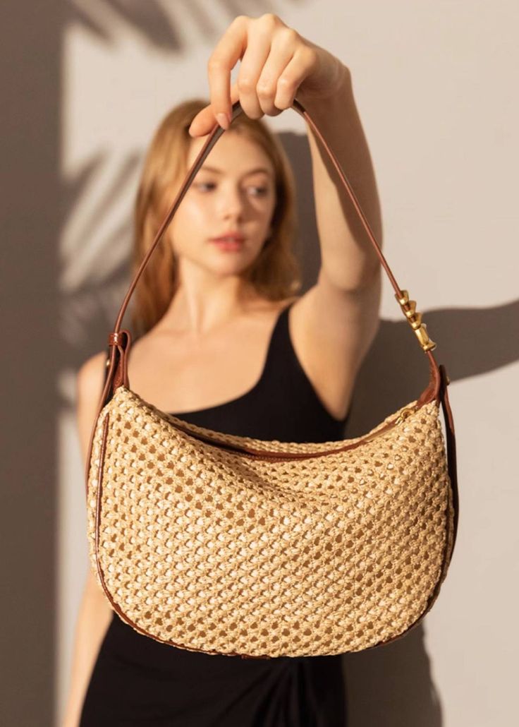 Indulge in luxury with our Woven Raffia Saddle Bag, expertly crafted with a blend of raffia and leather. Its adjustable shoulder strap ensures a perfect fit for women of all sizes. Elevate your style with this exclusive and elegant addition to your wardrobe. Size info 10 5/8" (27cm) width 6 3/4"(17cm) height 3"(8cm) depth Details Raffia and genuine cowhide leather Polyester lining Adjustable shoulder strap Interior wall pocket and zipper pocket Top zip closure Item #462501 Women's saddle shoulde Women Of All Sizes, Woven Raffia, Pocket Top, Interior Wall, Saddle Bag, Wall Pockets, Bag For Women, Sweater Coats, Two Piece Outfit