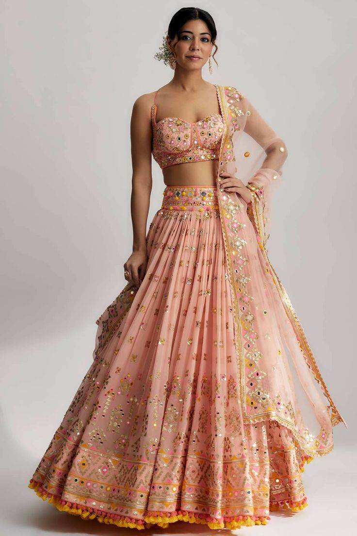 This lehenga set is perfect for a glamorous wedding ceremony, as it exudes elegance and grace. The vibrant colors and shimmering sequins make it a statement piece that will surely turn heads and leave a lasting impression. Be prepared to steal the spotlight and make a memorable entrance in the ruah gathered lehenga set. Its beautiful craftsmanship, intricate details and vibrant colors will make you feel like a queen on your special day. Gathered Lehenga, Middle Class Family, Class Family, India Trip, Lehenga Design, Indian Outfits Lehenga, Lehenga Designs Simple, Indian Bride Outfits, Outfits Dresses