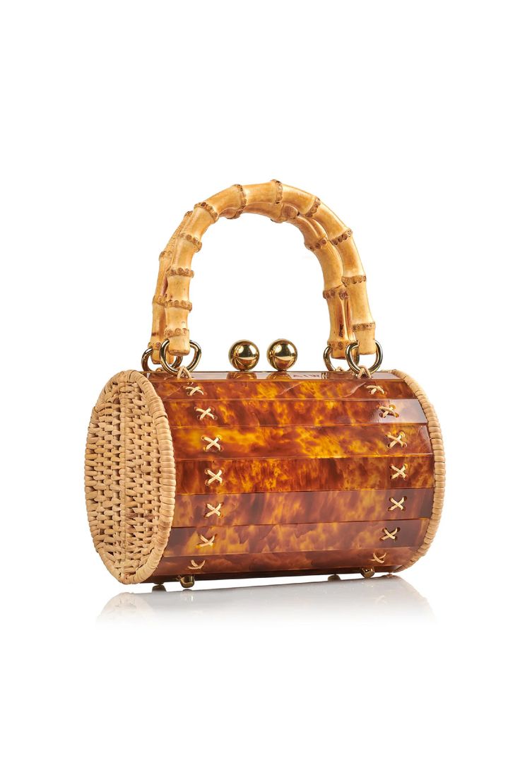 Meet the Alix Bambu Turtle Bag, a versatile and stylish addition to your accessory collection. Featuring a charming bamboo handle and a removable leather shoulder strap, this bag seamlessly transforms from a shoulder bag to a crossbody or handbag. It is a unique blend of handwoven, natural rattan and modern acrylic, which creates a playful yet sophisticated look. Perfect for any occasion, this bag is your go-to for effortless style and functionality. Rectangular Straw Bag With Bamboo Handle For Evening, Elegant Natural Bucket Bag With Bamboo Handle, Evening Rectangular Straw Bag With Bamboo Handle, Luxury Crossbody Bag With Bamboo Handle, Evening Bag With Bamboo Handle In Natural Color, Evening Shoulder Bag With Bamboo Handle In Natural Color, Luxury Rectangular Shoulder Bag With Bamboo Handle, Natural Shoulder Bag With Bamboo Handle For Evening, Evening Shoulder Bag With Bamboo Handle