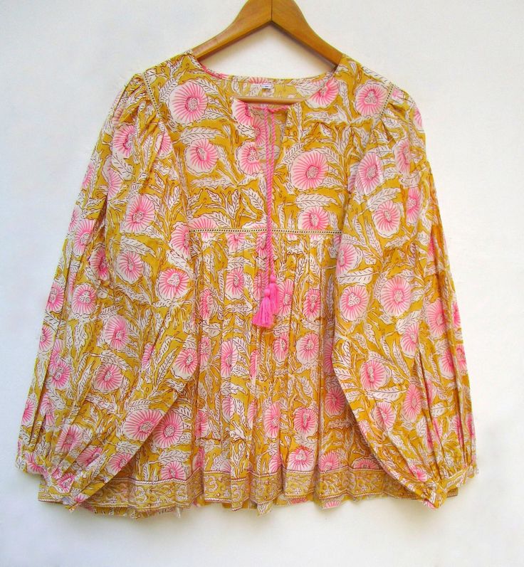 "ITEM DESCRIPTION yellow pink blossom floral printed cotton blouse and tops - Henley neckline with tassel blouse - long sleeve with buttons blouse - with lace Features : Long sleeve, Henley neck, Blouse Material : Cotton cambric Fabric: 100% cotton soft light weight ethnic print fabrics Sleeve Length = 22 inch For more sizes & their measurement, please refer our below chart to understand the sizes variations available with us For your size requirement, please mention your size in seller note at Pink Lace Henley Top, Cheap Pink Boho Print Top, Colorful Blouses For Women, Pulse Size Summer Outfits, Long Sleeve Cotton Peasant Top With Boho Print, Feminine Printed Cotton Blouse, Long Sleeve Floral Print Peasant Top, Spring Peasant Top With Boho Print And Long Sleeves, Feminine Long Sleeve Cotton Peasant Top