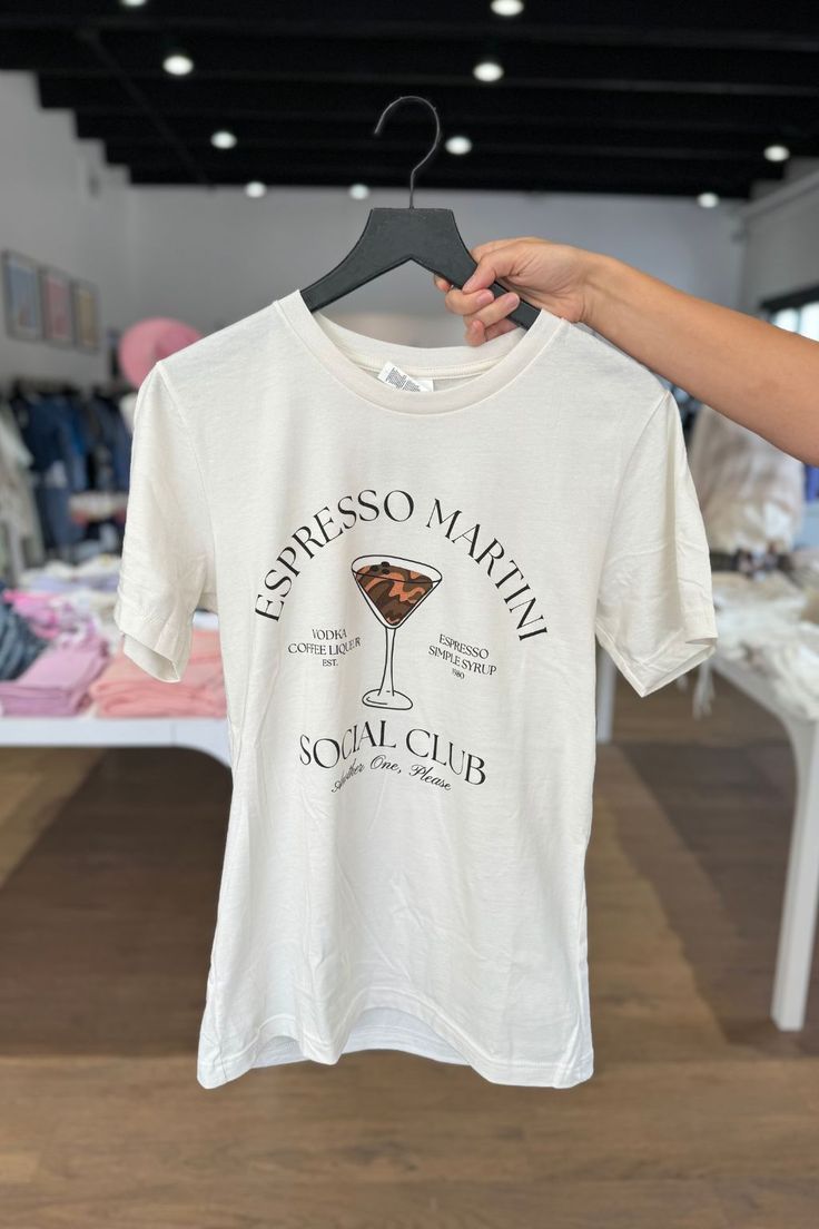 Loosen up and have some fun with the Espresso Martini Graphic T-Shirt. Featuring a stylish martini glass design, this tee adds a touch of personality to your ensemble. Whether it's happy hour or any other occasion, this tee effortlessly combines style and comfort. Embrace the relaxed and charming vibe of the Espresso Social Club with this must-have top. Cheers to being effortlessly cool! Model is wearing a size Small: 5'2" Bust 34B Waist 26" Martini Graphic, Sleeveless Sweater Cardigan, Maxi Romper, 40 Dress, Espresso Martini, Blouse Sleeveless, Everyday Basics, Shoe Gifts, Little White Dresses