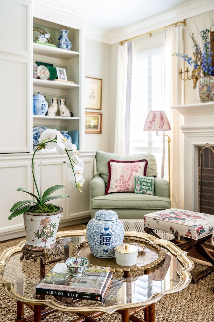 a living room filled with furniture and a fire place in the centerpiece, surrounded by bookshelves