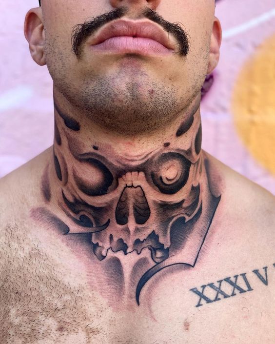 a man with a skull and cross tattoo on his chest