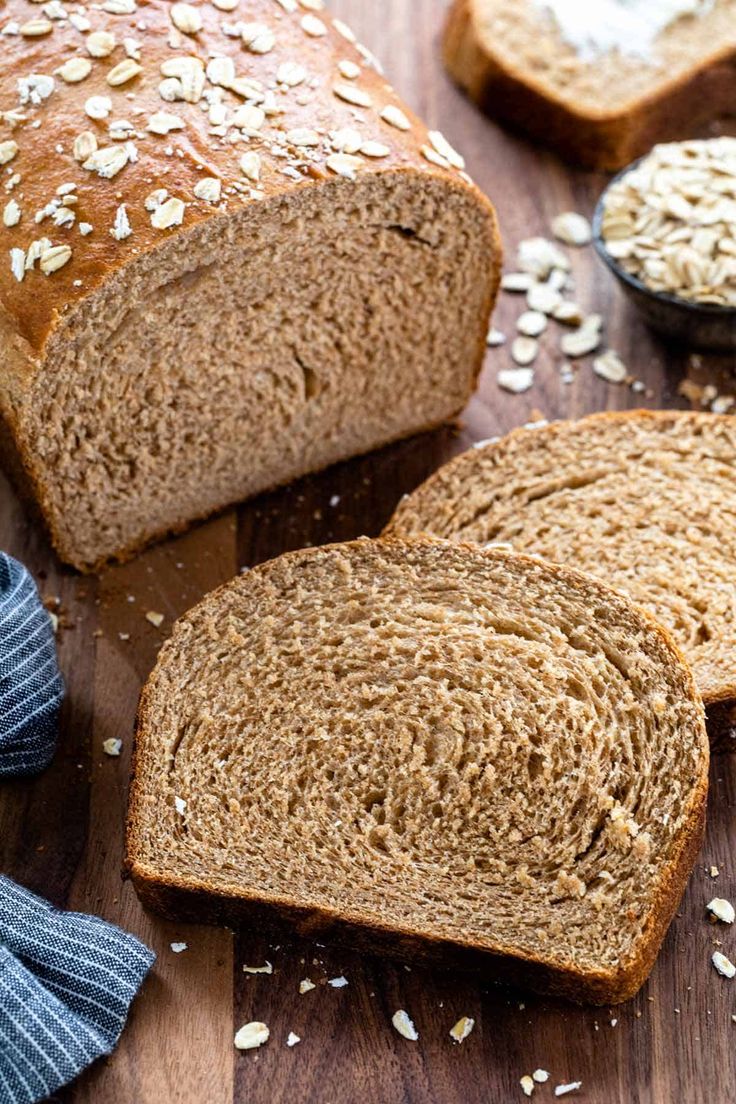 two loaves of whole wheat bread on a cutting board