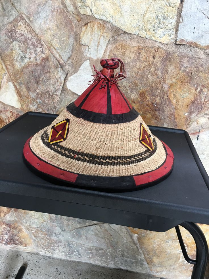 This beautiful woven hat is made by talented craftsmen living in Accra and it's surrounding villages. It's made using dried grass and leather popularly called Fulani hat. MEASUREMENTS Diameter: 14 inches Wide Height: 10 inches USES This hat is ideal to compliment your fashion sense and also, to prevent direct sunlight from burning your head. Artisan Brown Straw Hat, Brown Artisan Toquilla Straw Hat, Brown Woven Straw Hat Artisan Style, Traditional Brown Straw Hat With Curved Brim, Traditional Brown Wide Brim Straw Hat, Artisan Straw Sun Hat In Brown, Artisan Brown Straw Sun Hat, Traditional Brown Hat With Short Brim, Brown Woven Palm Leaf Hat