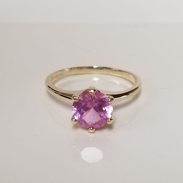 "Thanks for shopping our vintage estate store. We tend to sell well below wholesale and truly hope you enjoy all of our items. Many of the items are one of a kind, so please enjoy scrolling through the pictures and hopefully something will catch your eye. Brown spots are from camera or reflections. Estate 10k yellow gold created pink topaz 2ct pink or ice cocktail ring. Round cut stunning gem and no scratches on the gem. Gem is testing sapphire but may be topaz as well. Ring size: 8.25 Setting:  8mm 3/8\" Gem:  8mm 2cts Band Width: 2mm Weight: 2.61 grams Sweet ring, one that you will love. Marked 10k." Classic Pink Gemstone Birthstone Ring, Classic Pink Birthstone Ring, Pink Birthstone Ring In Classic Style, Classic Topaz Birthstone Ring With Round Band, Classic Pink Topaz Ring With Prong Setting, Classic Topaz Ring With Birthstone In Round Band, Classic Pink Topaz Ring For Anniversary, Classic Pink Round Birthstone Ring, Classic Pink Round Topaz Ring