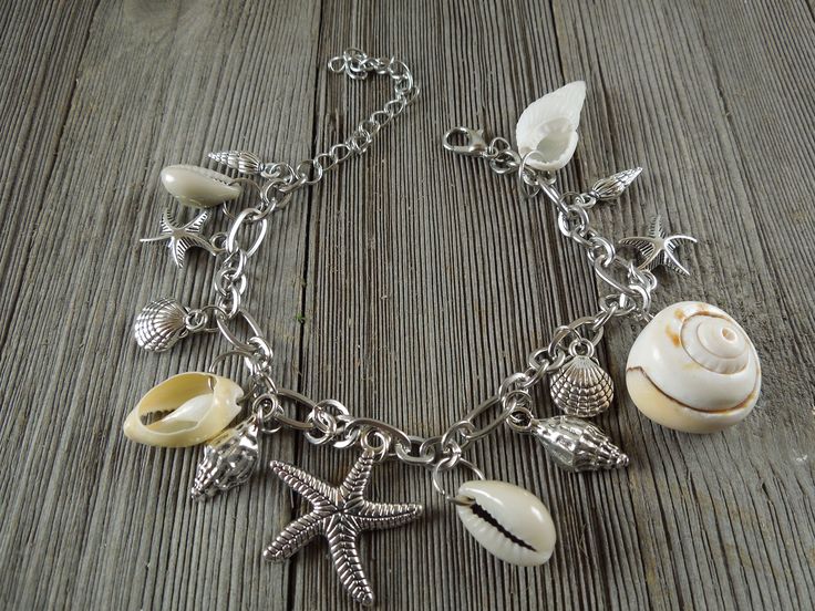 "Amazing and beautiful Natural Shell Anklet bracelet with silver starfish shell charm, Conch shell Ankle bracelet. Seashell jewelry, bohemian jewelry ankle Dancing in the sand anklet is (7 7/8\") with 2.5\" extension 5 Natural Conch shell connected to the bracelet, 9 metal shell charms." Silver Charm Bracelet With Lobster Clasp For Beach, Silver Charm Bracelet For The Beach, Silver Starfish Charm Bracelet For Beach, Silver Charm Bracelet With Starfish For Beach, Bohemian Silver Charm Bracelet For Beach, Silver Bohemian Charm Bracelet For Beach, Handmade Silver Charm Bracelet For Beach, Bracelet Seashell, Anklet Silver