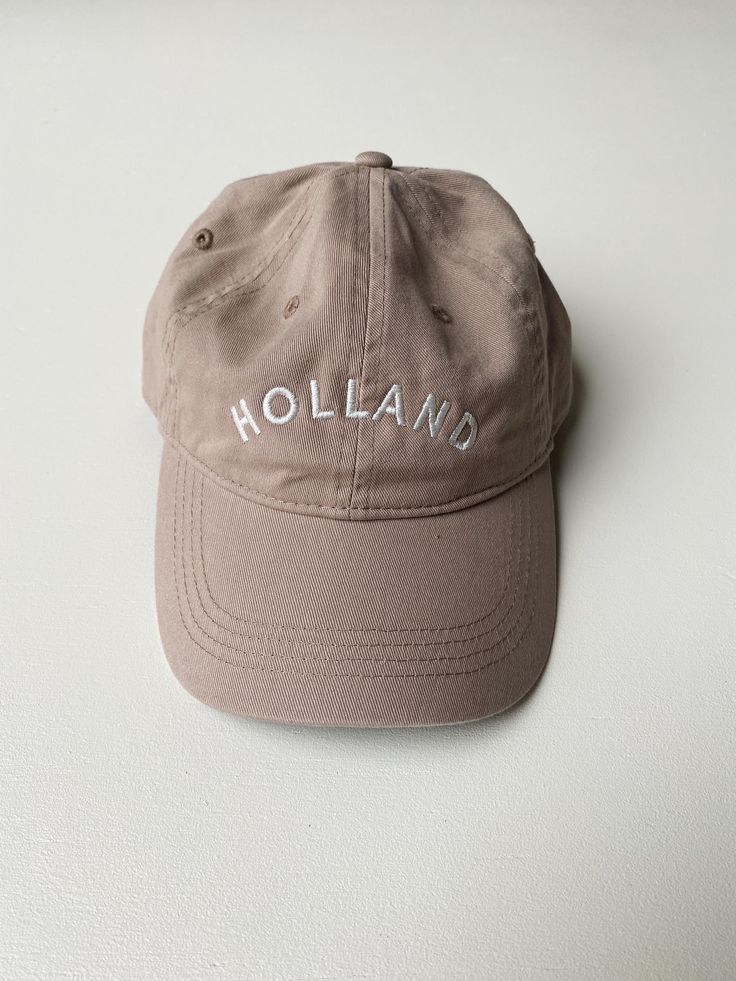 This Holland "Dad Hat" is a classic. The neutral tones are sure to match every outfit all year round. Embroidered locally in Grand Rapids. Regular fit 100% Cotton Hand wash Classic Cream Baseball Cap For Spring, Beige Summer Hats With Embroidered Logo, Adjustable Beige Dad Hat For Spring, Brown Hats With Embroidered Logo For Summer, Brown Hat With Embroidered Logo For Summer, Casual Embroidered Baseball Cap With Short Brim, Brown Summer Hats With Embroidered Logo, Beige Hat With Embroidered Logo And Short Brim, Beige Dad Hat For Spring, One Size Fits Most