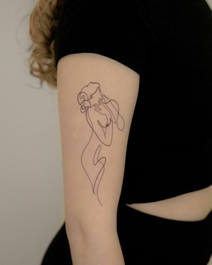 a woman with a tattoo on her arm