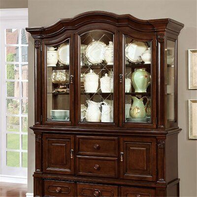 a large wooden china cabinet with glass doors