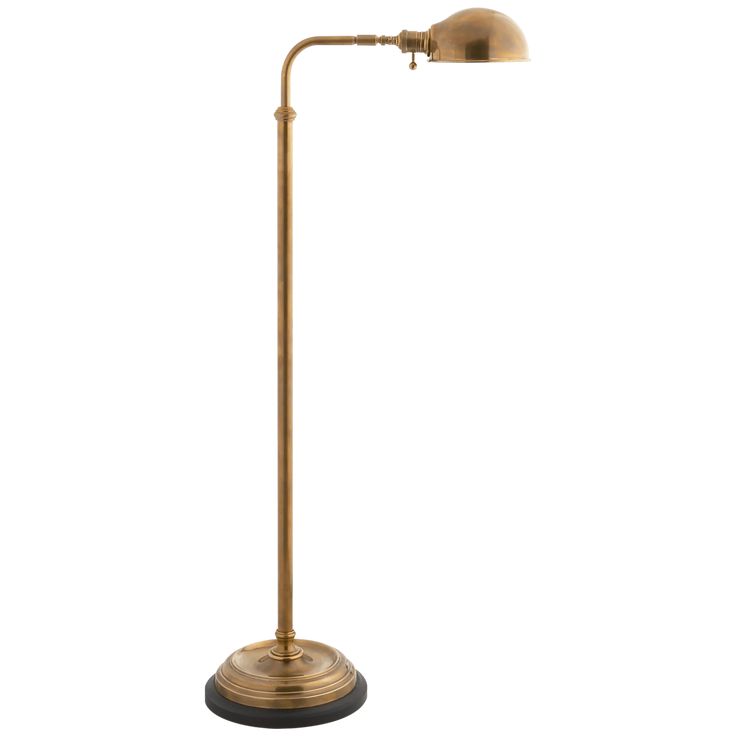 an antique brass floor lamp on a white background