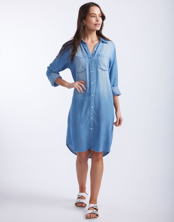 DESCRIPTION Introducing the Cleo Vintage Denim dress by White & Co. This must-have Spring wardrobe essential brings effortless style with its laid-back, vintage look. Crafted from soft, lightweight, breathable tencel denim, this shirt dress features a button-down front, twin chest pockets, and a flattering curved hem. Perfect for those days when you want to look chic without trying too hard. Pair the Cleo Vintage Dress with white sneakers for a casual day out, or dress it up with strappy sandals Washed Button-up Denim Dress With Relaxed Fit, Medium Wash Cotton Denim Dress With V-neck, Vintage Denim Dress, Tencel Denim, Spring Wardrobe Essentials, Medium Wash Cotton Button-up Shirt Dress, Medium Wash Cotton Button-up Denim Dress, Non-stretch Medium Wash Denim Dress With Button Closure, Denim Shirt Dress