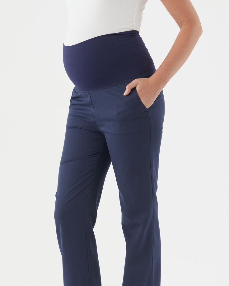 Four way stretch active fabric waistband Wide leg silhouette Side pockets Inseam length: 78cm The Emma Overbelly Straight Pant is our answer to your corporate maternity wardrobe needs! This pant is made from a lightweight crease resistant suiting fabric, giving it a professional finish. The overbelly waistband, which is in our four way stretch active fabric, allows you to feel comfortable and secure and can also be worn folded down below the bump. The pants feature side pockets and closed welt p Maternity Bottoms With Elastic Waistband And Stretch, Maternity Stretch Bottoms With Elastic Waistband, 4-way Stretch Bottoms With Side Pockets For Work, Comfort Stretch Workwear Bottoms With Pockets, Comfort Stretch Bottoms With Pockets For Work, Workwear Bottoms With Side Pockets And 4-way Stretch, Workwear Pants With 4-way Stretch And Side Pockets, Bump Friendly Fitted Maternity Pants, Fitted Maternity Pants Bump Friendly