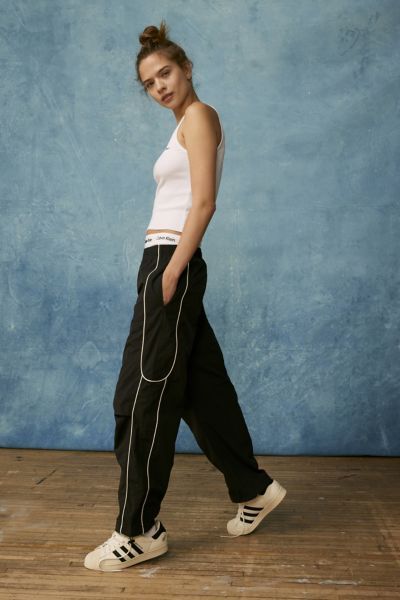 Effortless track pants from BDG. Our BDG Jess nylon track pants have an easy fit with a low rise and a relaxed straight leg. Essential track pants styling with contrasting piping at the sides. Find these staple track pants only at Urban Outfitters. Features BDG Jess nylon track pants with piped detailing Relaxed style with classic track pant styling Side pockets Pull-on style UO exclusive Content + Care 100% Nylon Machine wash Imported Size + Fit Model in Black is 5’10" and wearing size Small Me Sporty Straight Cargo Pants For Summer, Sporty Black Parachute Pants For Summer, Sporty Straight Leg Summer Cargo Pants, Sporty Straight Parachute Pants For Streetwear, Sporty Straight Cargo Pants For Spring, Sporty Straight Parachute Pants With Cargo Pockets, Trendy Nylon Pants For Streetwear, Sporty Parachute Trousers For Streetwear, Spring Streetwear Joggers With Elastic Side Panels