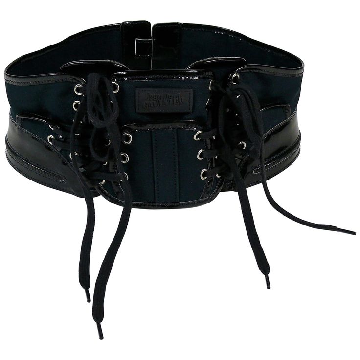 JEAN PAUL GAULTIER collector boxing corset belt. This belt features : - Dark navy blue canvas panels embellished with black patent PVC details. - Black laces on front. - Silver toned eyelets. - Rubber JEAN PAUL GAULTIER patch on the frontal panel. - Velcro fastening on the back. Indicated sizes : US 12 / UK 14 / FR 80. Made in France. Indicative measurements : adjustable length from approx. 78 cm (30.71 inches) to approx. 79 cm (31.10 inches) / max. width approx. 12 cm (4.72 inches). BELT CONDIT Black Leather Gothic Corset Belt, Black Leather Corset Belt With Belt Loops, Luxury Black Corset Belt With Belt Loops, Black Luxury Corset Belt With Belt Included, Luxury Black Corset Belt With Belt Included, Punk Style Black Corset Belt With Included Belt, Black Leather Corset Belt With Belt Detail, Black Gothic Corset Belt With Belt Loops, Black Punk Corset Belt With Belt Loops