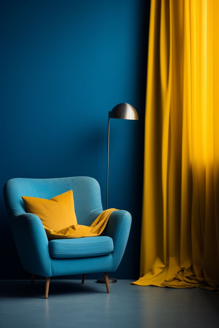 a blue chair sitting in front of a yellow curtain