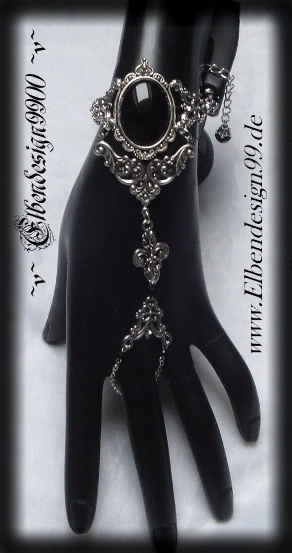 A very beautiful Gothic-style hand jewellery, which, like all my jewellery, was made with great care and attention to detail. The bracelet is made of silver plated metal components with black onyx and black diamond rhinestones. adjustable for an arm circumference of approx. 15-21 cm. Gothic Nickel-free Metal Body Jewelry, Nickel-free Gothic Metal Body Jewelry, Handmade Gothic Body Jewelry For Party, Elegant Handmade Silver Body Jewelry, Gothic Metal Jewelry For Fantasy Events, Gothic Silver Metal Body Jewelry, Silver Gothic Jewelry For Fantasy Events, Silver Gothic Metal Body Jewelry, Silver Gothic Body Jewelry