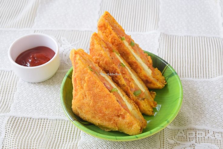 some fried food is on a green plate next to a small bowl and dipping sauce