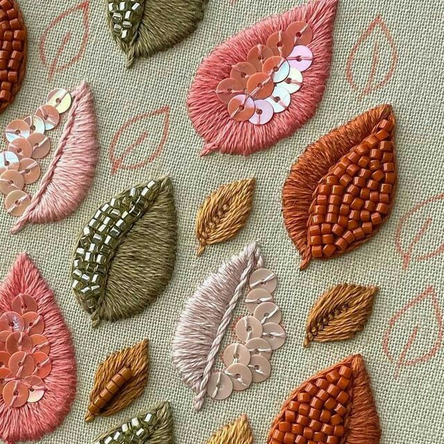 several different types of embroidered flowers on a piece of fabric