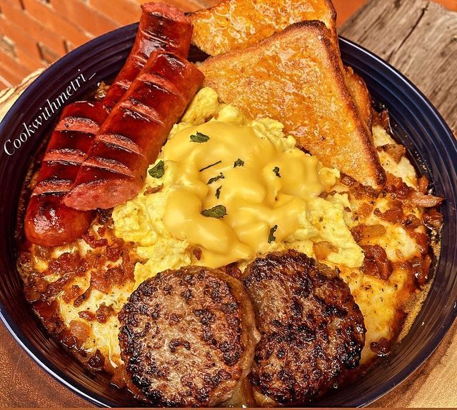 a breakfast plate with sausage, eggs, toast and hashbrowns on it