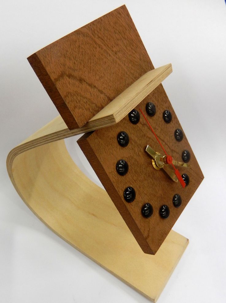 a clock made out of wood with black knobs