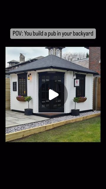 a small white house with black doors and windows