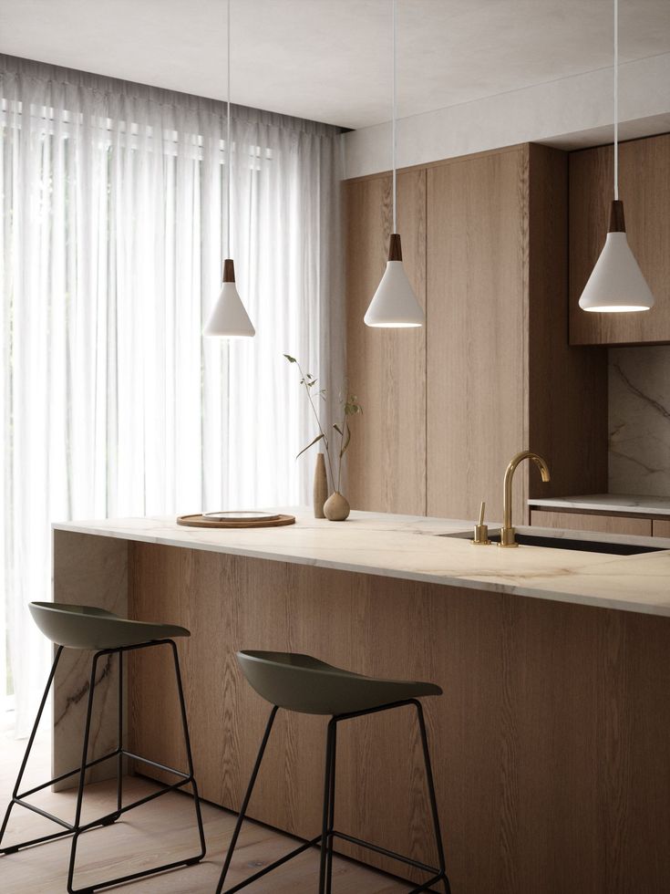 two bar stools sit in front of an island with marble countertops and white curtains