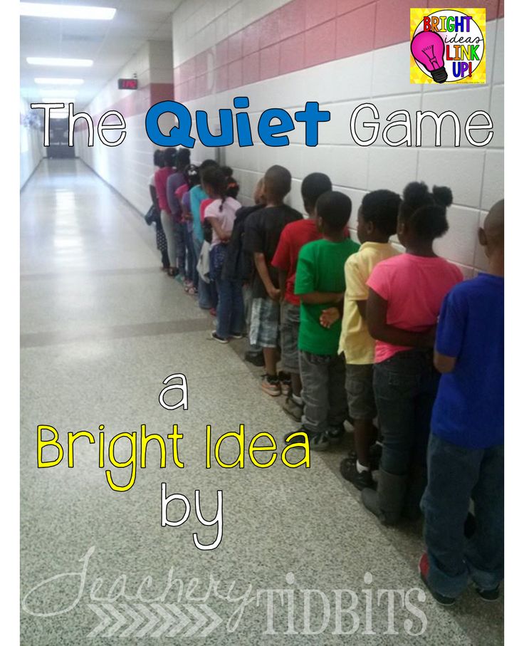 a group of children lined up against a wall in front of a sign that says the quiet game