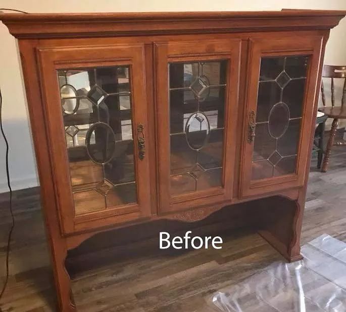 an old china cabinet has been refinished with new glass doors