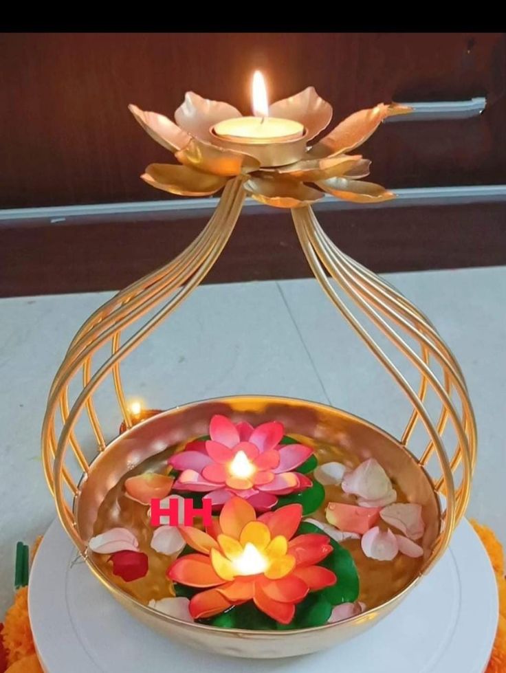 a decorative candle holder with flowers floating in it