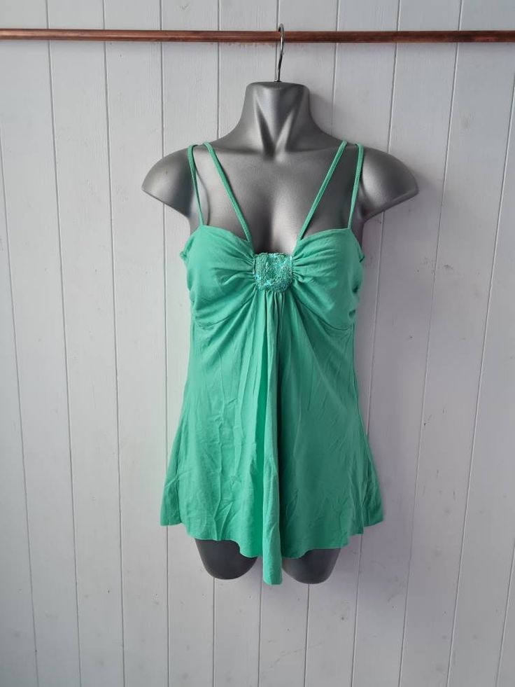 Strappy green vintage 90s y2k top with sequin detail, acemetric hem No labels but approx UK8/10 US 4/6 Unusual wearable top Good pre-loved condition  Measurements:(unstretched) 15" pit to pit  25" strap to hem side 20" length centre top to point at front Y2k Tops With Spaghetti Straps And Built-in Bra, Green Tops With Built-in Bra For Spring, Green V-neck Y2k Tops, Y2k Style Stretch Tops With Built-in Bra, Green Stretch Camisole With Spaghetti Straps, Green Y2k Style Summer Top, Green Summer Y2k Tops, Green Y2k Summer Tops, Y2k Camisole Top With Built-in Bra