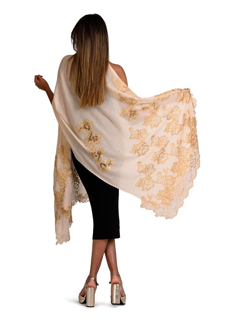 Woven from the finest cashmere, this beige scarf features an intricately handcrafted application of an exotic gold Chantilly lace extending inward in a vine pattern from the ends of the scarf. The luxurious cashmere fabric ensures both warmth and comfort whilst the stunning lace application adds a touch of sophistication with unparalleled charm, giving this scarf timeless appeal with a modern edge. You can style yourself with versatile ease in multiple ways, making this scarf the perfect accesso Elegant Embroidered Scarves For Festive Occasions, Elegant Cream Scarves For Festive Season, Elegant Dupatta With Gold Embroidery, Elegant Gold Embroidered Dupatta In Traditional Drape, Elegant Gold Embroidered Dupatta, Elegant Cream Shawl Dupatta, Elegant Cream Embroidered Shawl, Elegant Cream Pashmina Shawl In Traditional Drape, Elegant Silk Shawl With Chikankari Embroidery