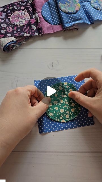 someone is making a paper plate with flowers and polka dots on the top, while another person holds it in their hands