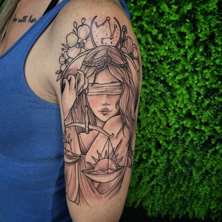 a woman's arm with a tattoo on it that has a lady holding an hourglass in her hand