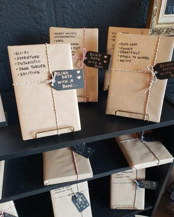 several books are wrapped in brown paper and tied with twine on the shelf next to each other