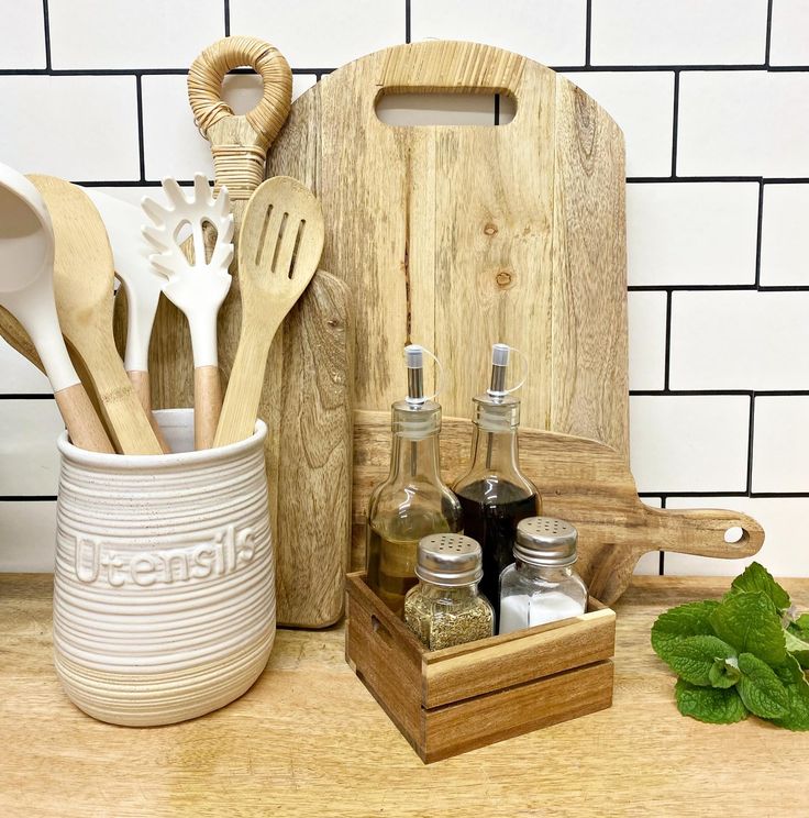 the kitchen utensils are sitting on the counter next to the cutting board and knife holder