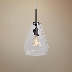 a clear glass light fixture hanging from a metal ceiling lamp with a black cord and an old fashioned bulb on the end