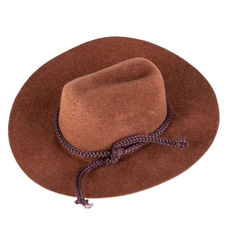 Mini Brown Flocked Cowboy Hat. This Small Brown Flocked Cowboy Hat is a great accessory for displaying with various western decor and fashioning with small dolls and stuffed animals.    The cowboy hat is covered in brown velveteen coating and its crown is detailed with rope trim. This small cowboy hat makes for a darling placeholder or favor for western-themed, events, barbecues, and weddings.    Made of felt, plastic, and polyester. Brown Felt Hat Band For Rodeo, Brown Felt Hat Bands For Rodeo, Brown Top Hat With Curved Brim For Western-themed Events, Brown Flat Brim Felt Hat For Country Events, Western Brown Top Hat For Country Events, Brown Curved Brim Top Hat For Western-themed Events, Brown Flat Brim Costume Hat For Rodeo, Western Brown Costume Hats And Headpieces For Country Events, Western Style Brown Cap Costume Hat