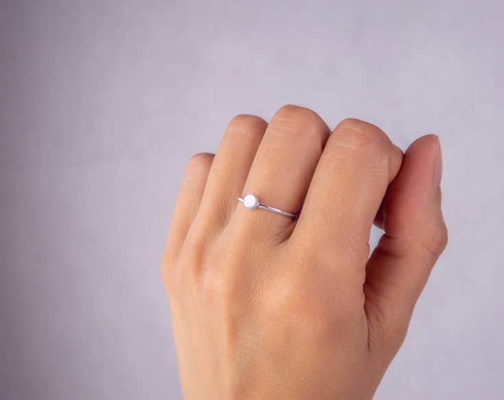 Dainty Ring made of 925 Sterling Silver and set with white Mother of Pearl. All the jewelry will arrive in a gift box. Free shipping includes a tracking number. Does not require any signature to be delivered: packet is placed directly in the mailbox. Discover all our Silver rings here: https://etsy.me/2Rj0BBB Device for finger/ring measurement available here: https://www.etsy.com/fr/listing/636720825/bague-a-mesurer-les-doigts-trouvez-votre?ref=shop_home_active_1 White Solitaire Pearl Ring, White Solitaire Pearl Ring, Round Cut, Minimalist Sterling Silver Stackable Rings With Brilliant Cut, White Dainty Diamond Ring With Single Diamond, Dainty White Diamond Ring With Single Diamond, White Single Diamond Dainty Ring, White Solitaire Pearl Promise Ring, White Solitaire Pearl Ring Fine Jewelry, White Diamond Birthstone Ring For Anniversary