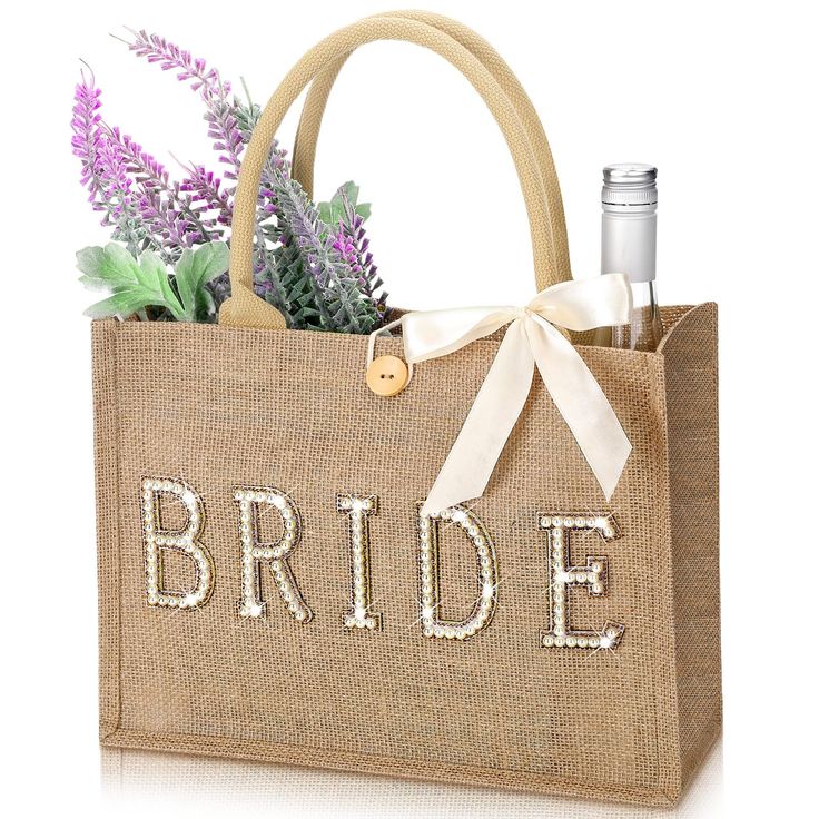 a burlap bag with the word bride written on it and flowers in front