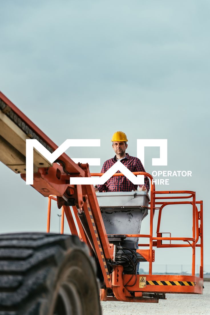 a man standing on top of a fork lift