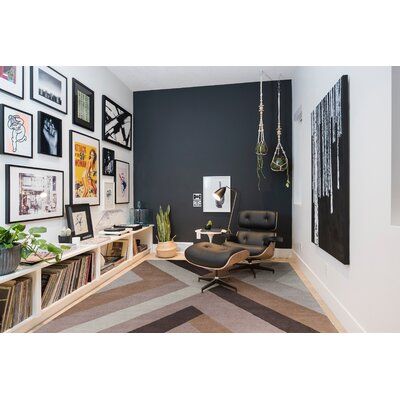 a living room filled with furniture and pictures on the wall