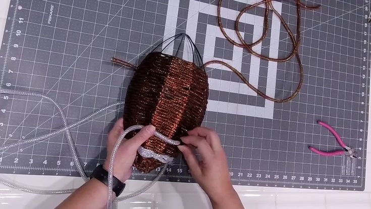 a person is working on something that looks like a bag with strings attached to it